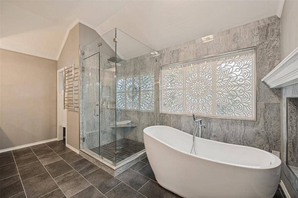 The wooden screen seen above the bathtub was made especially for this window to give some privacy and still allow light to shine through.