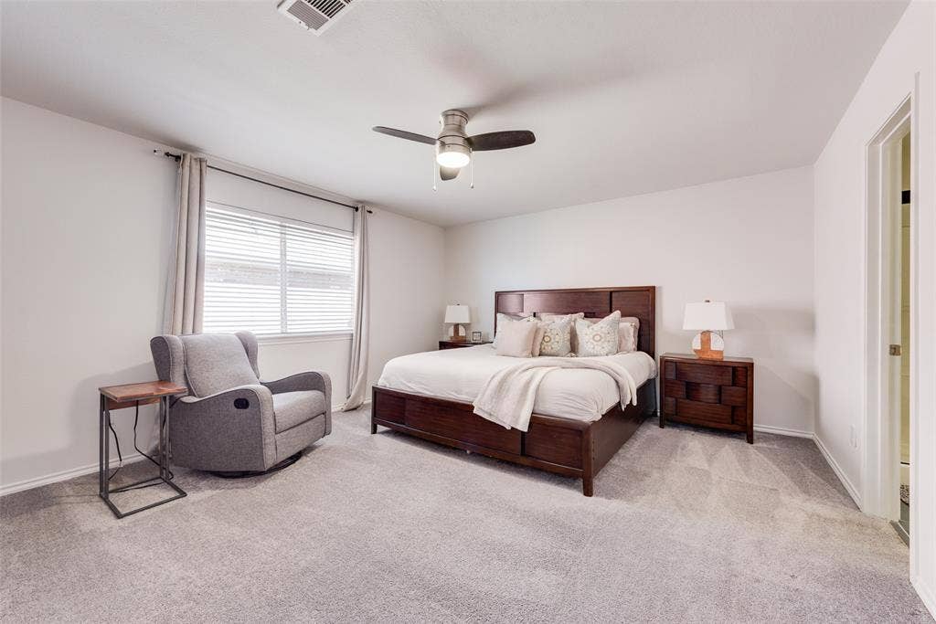 4104 Creekmeadow Drive, Carrollton, TX 75010 Neutral-toned carpeting, window featuring horizontal blinds, and a ceiling-mounted light fixture with an integrated fan