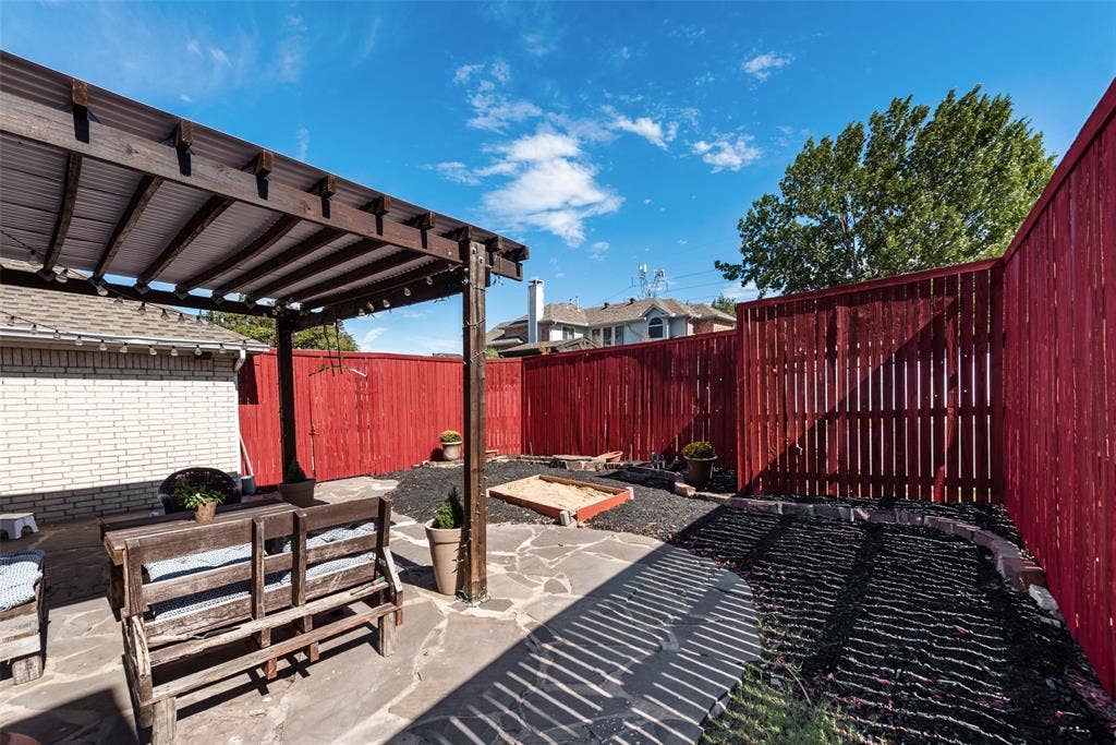 4104 Creekmeadow Drive, Carrollton, TX 75010 Outdoor living space featuring a wood pergola, flagstone patio, and perimeter wood privacy fencing