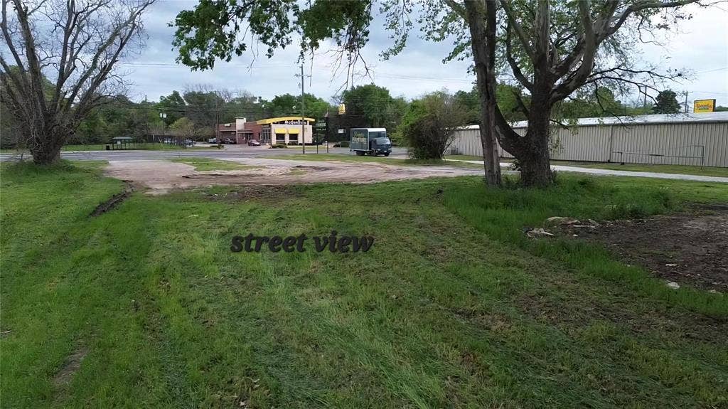 3110 W Gentry Parkway, Tyler, TX 75702 Open-level lot featuring mature trees and direct paved road access