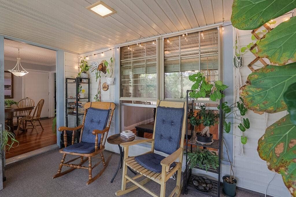 Covered patio featuring beadboard ceiling, recessed lighting, and expansive multi-pane windows