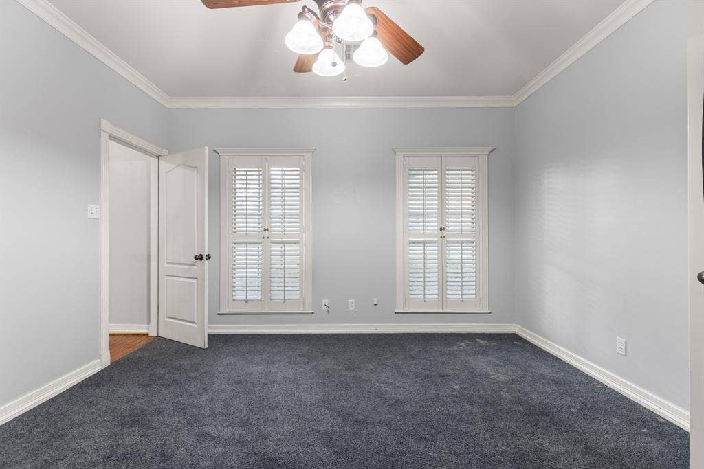 207 Westlane Circle, Woodway, TX 76712 Room featuring crown molding, neutral wall tones, plantation shutters, and a ceiling fan with integrated lighting