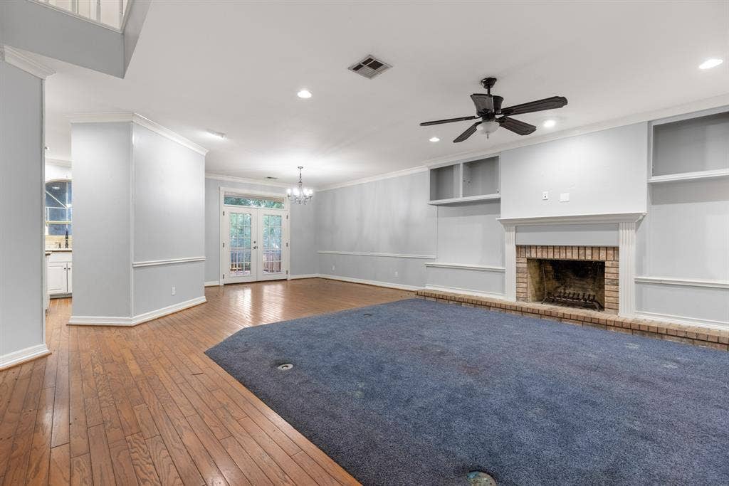 207 Westlane Circle, Woodway, TX 76712 Living area featuring wood-finish flooring, recessed lighting, a ceiling fan, and a brick-surround fireplace with built-in cabinetry and shelving