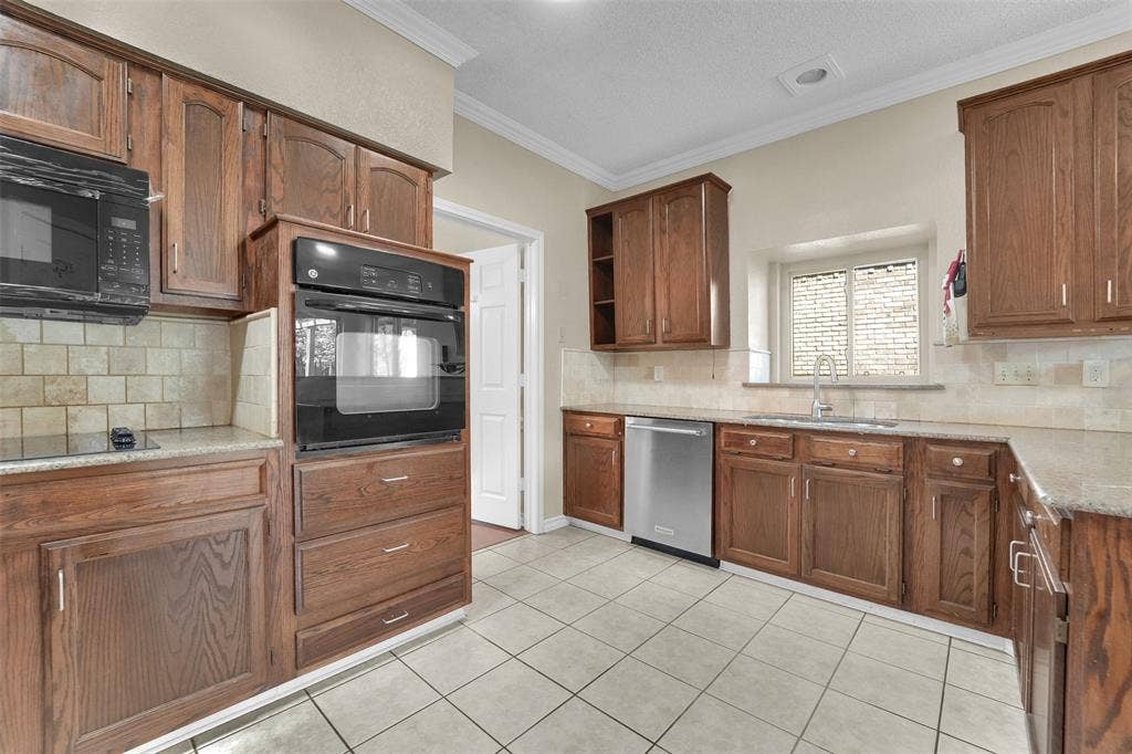 1920 Keystone Drive, Plano, TX 75075 Kitchen featuring wood cabinetry, stone-finish countertops, tile backsplash, built-in wall oven, and stainless steel dishwasher