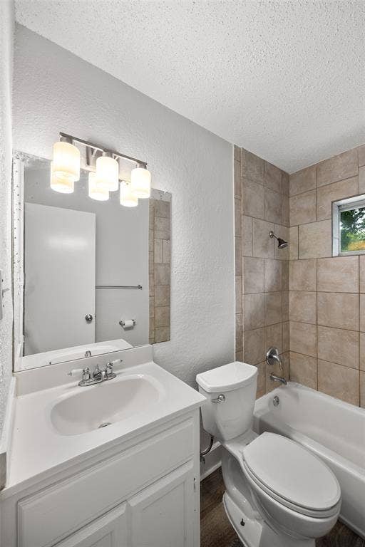 1605 Proctor Drive, Grand Prairie, TX 75051 Bathroom featuring a white vanity with integrated sink, chrome faucet, and a four-bulb vanity light fixture