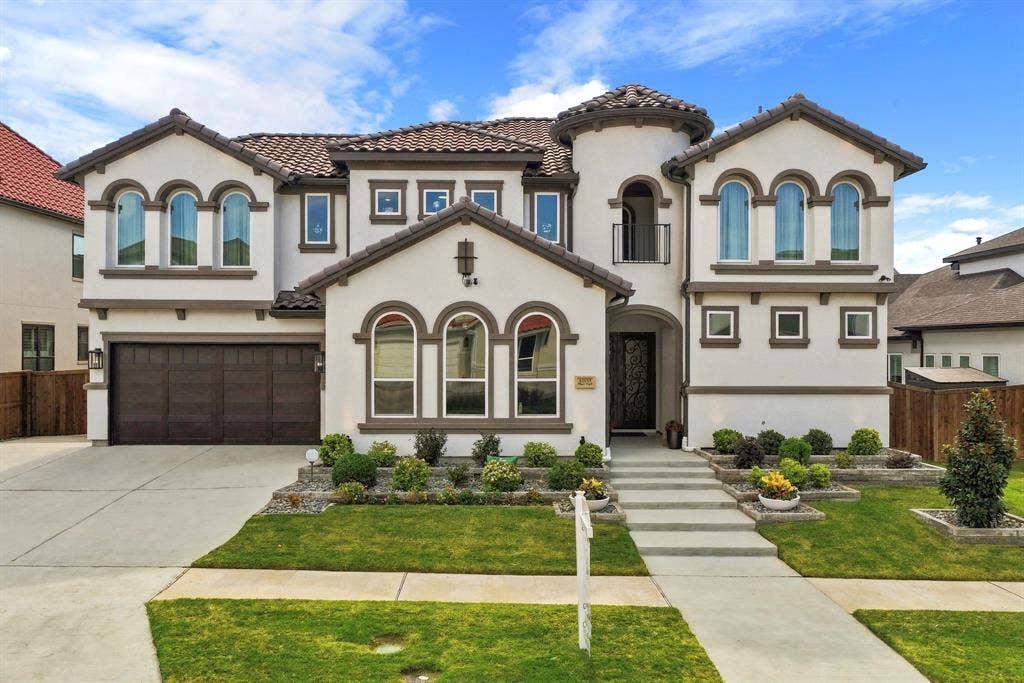 12173 Deer Trail, Frisco, TX 75035 Stucco exterior featuring arched windows, a multi-gabled tile roof, decorative turret, and attached multi-car garage