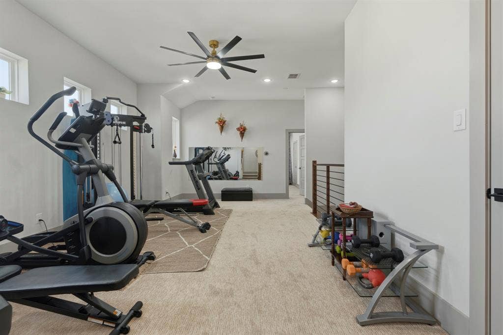 12173 Deer Trail, Frisco, TX 75035 Multi-purpose room featuring neutral carpeting, a large wall-mounted mirror, recessed lighting, a multi-blade ceiling fan, and metal-railing staircase accents