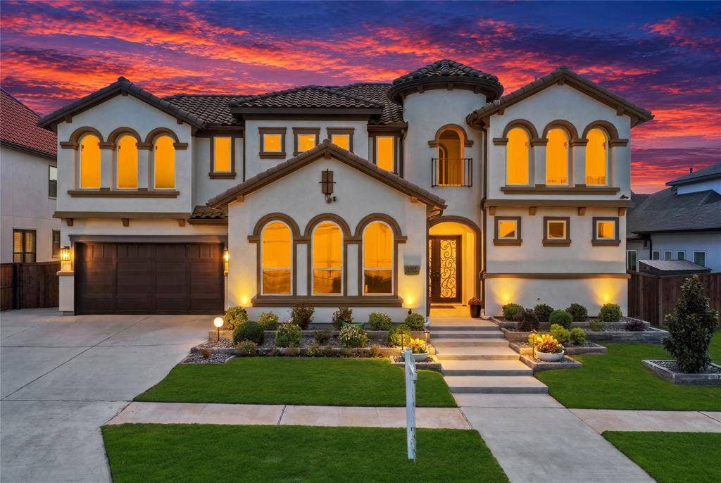 12173 Deer Trail, Frisco, TX 75035 Stucco exterior featuring arched windows, tile roofing, a turret architectural detail, decorative metal front door insert, and an attached multi-car garage