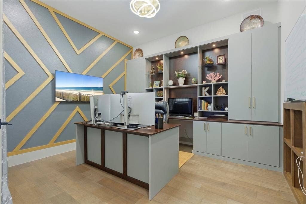 12173 Deer Trail, Frisco, TX 75035 Custom wall detailing featuring geometric gold-tone trim, built-in floor-to-ceiling cabinetry with integrated display shelving, recessed lighting, and wood-finish flooring
