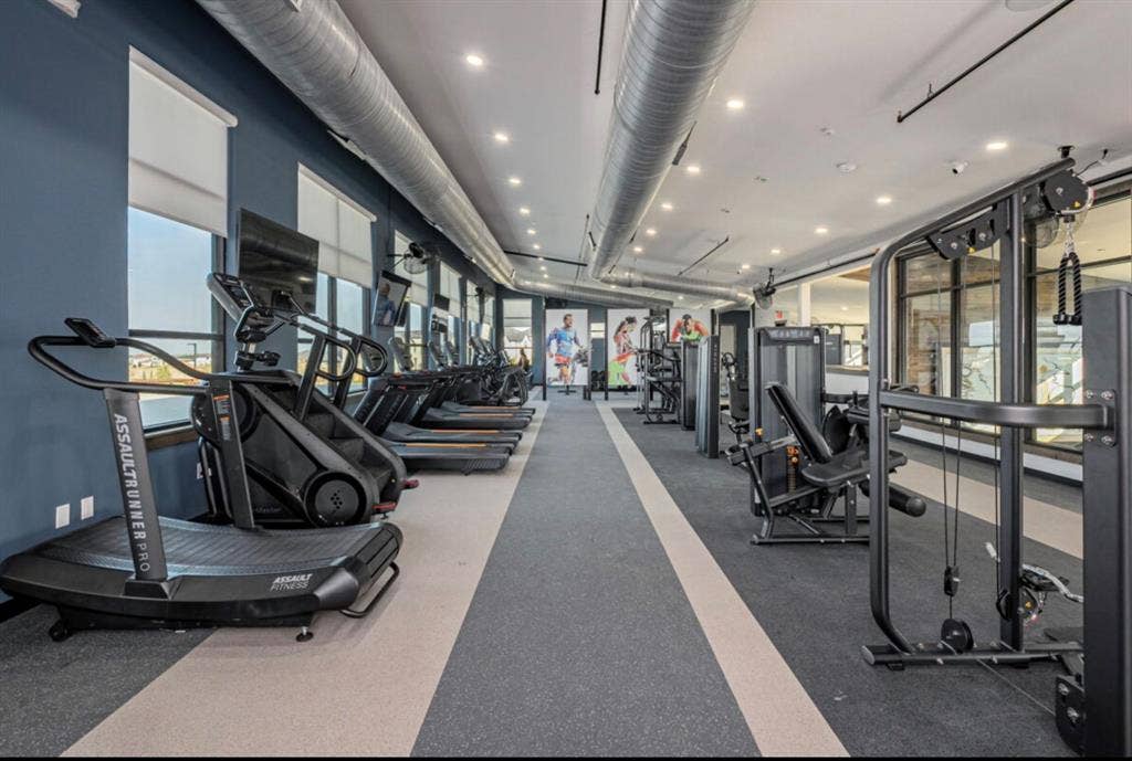 12173 Deer Trail, Frisco, TX 75035 Fitness center featuring industrial-style exposed ductwork, recessed lighting, expansive windows with roller shades, and durable flooring
