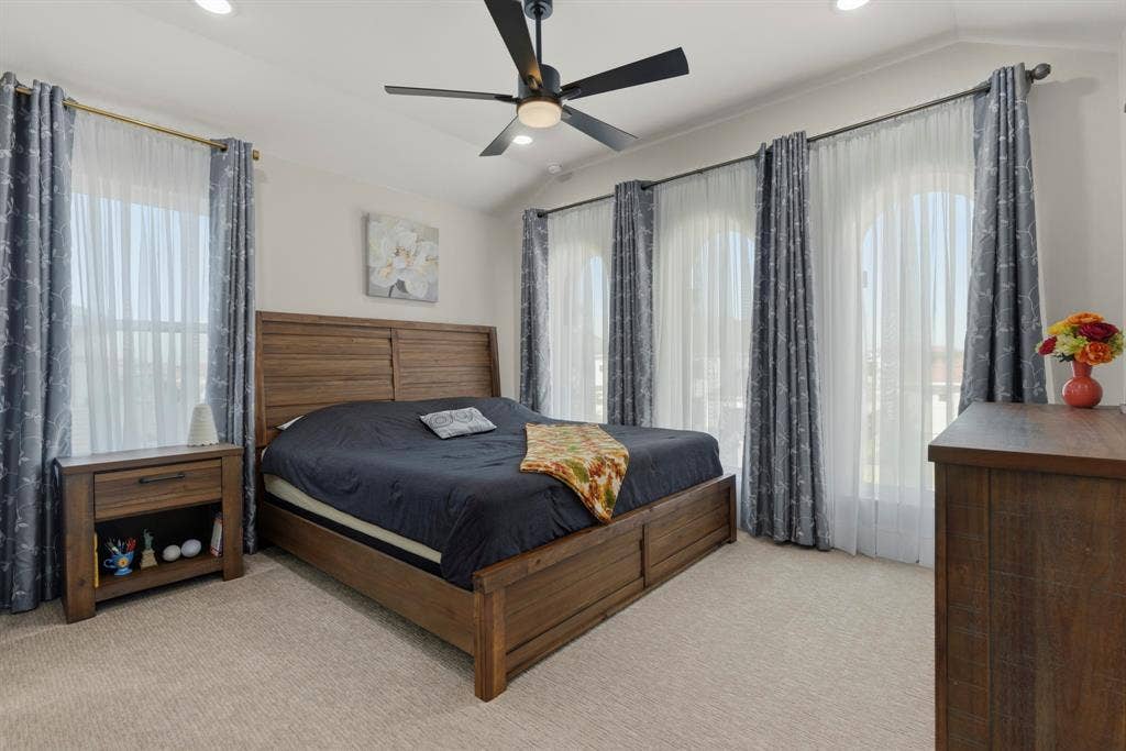 12173 Deer Trail, Frisco, TX 75035 Vaulted ceilings, three arched windows, wall-to-wall carpeting, and a matte black ceiling fan