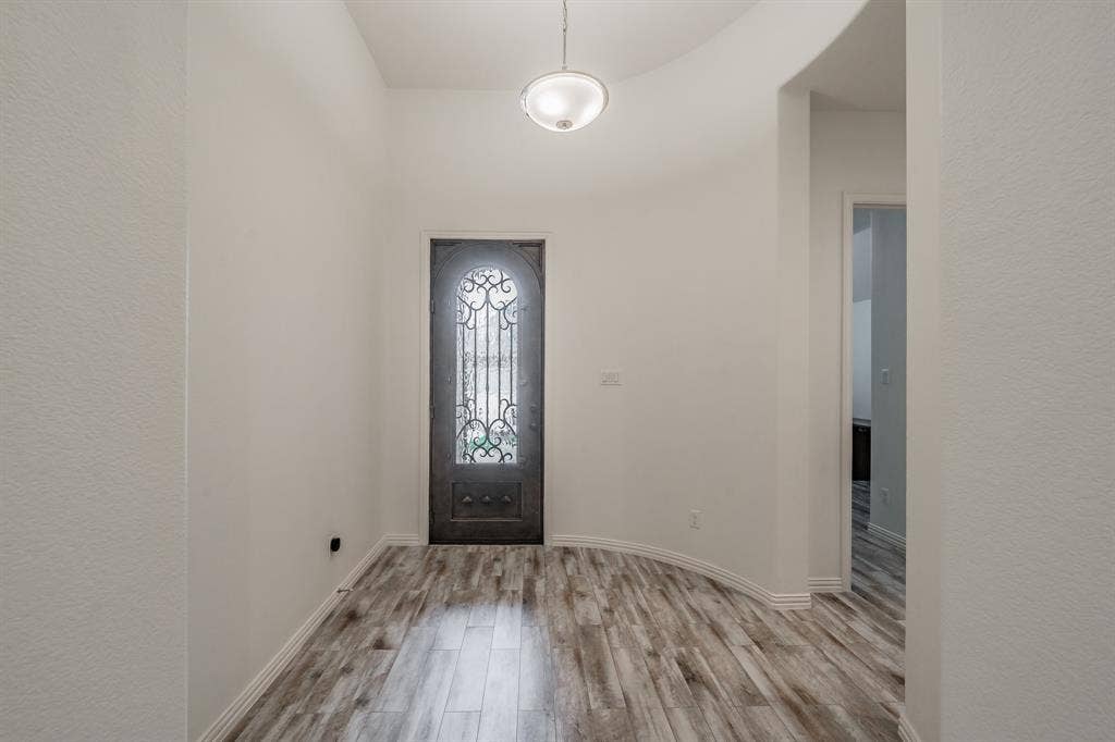 Entryway featuring wood finished floors and baseboards
