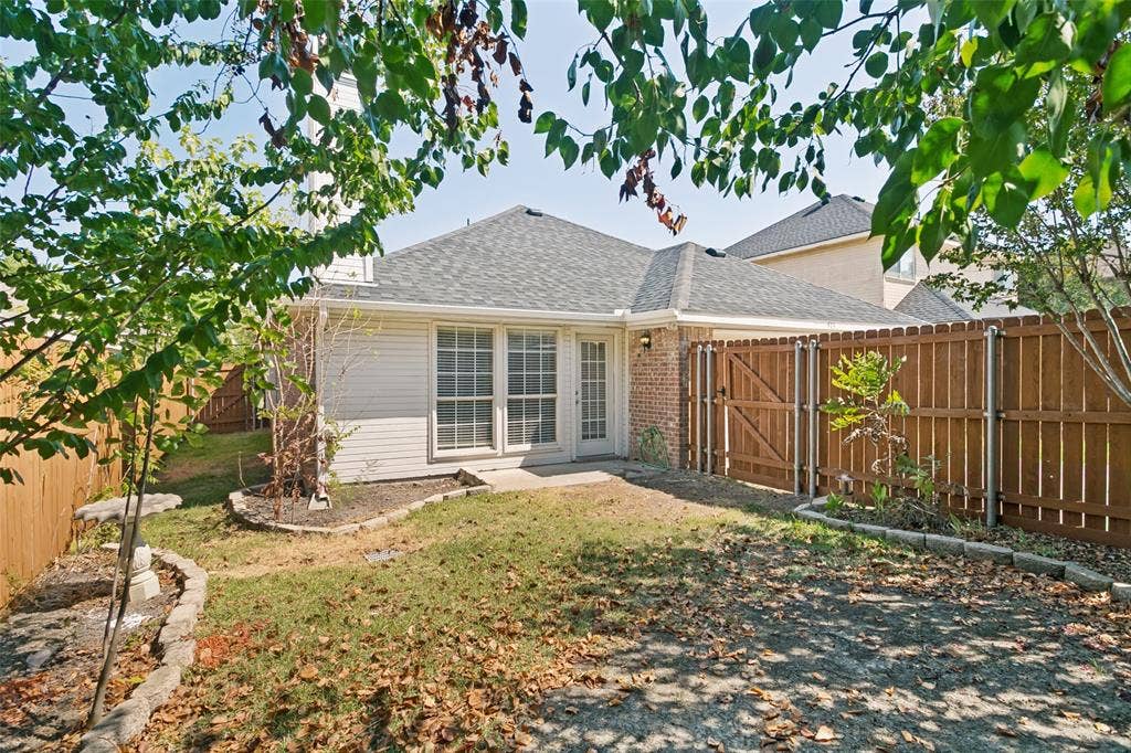 Backyard with mature trees and private fence.