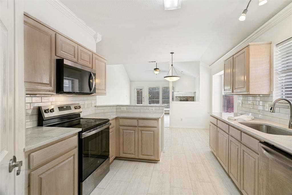 Open kitchen with new granite c-tops & tile backsplash.