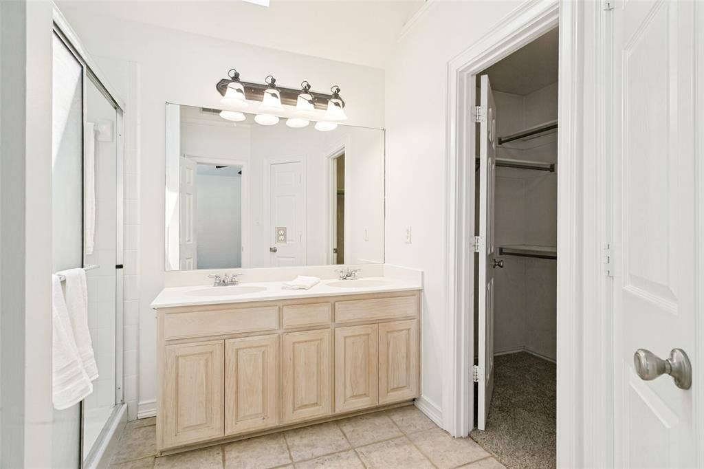 Primary bath with fresh paint and walk-in closet.