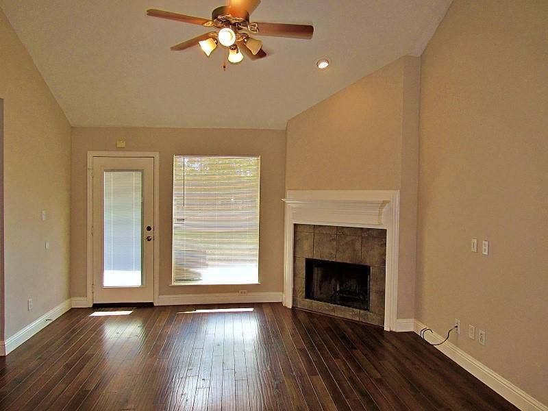 313 Timbercreek Court, Princeton, TX 75407 Vaulted ceilings, wood-finish flooring, corner fireplace with tile surround, and built-in mantle