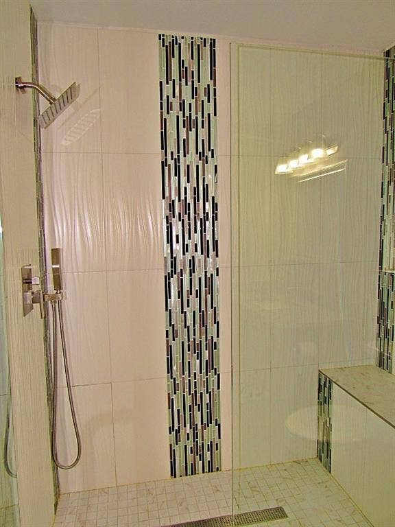 313 Timbercreek Court, Princeton, TX 75407 Walk-in shower featuring textured wall tile, a glass partition, a built-in tiled bench, mosaic accent banding, and a stainless steel rainfall shower head with a detachable handheld sprayer