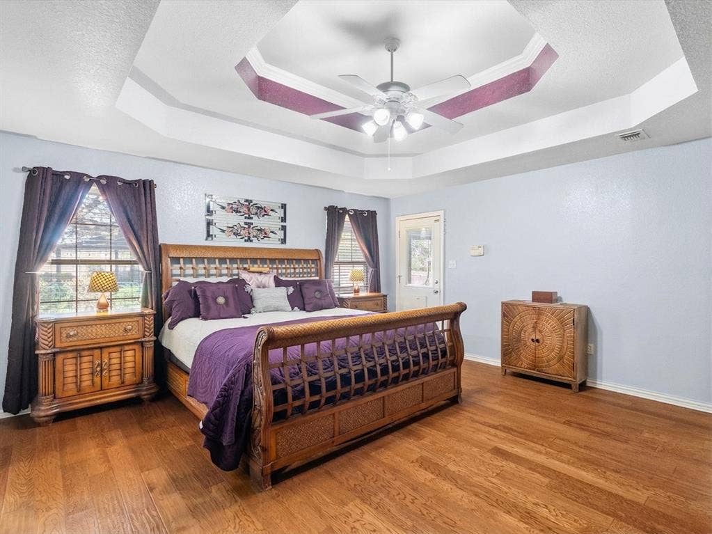 3103 Rim Rock Court, Granbury, TX 76049 Primary bedroom with wood floors and door to patio pool area