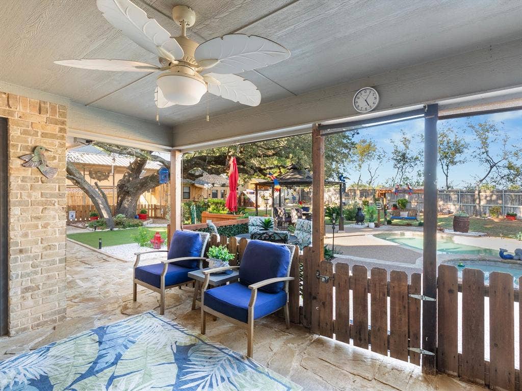 3103 Rim Rock Court, Granbury, TX 76049 Shady patio features picket fence and cool ceiling fan