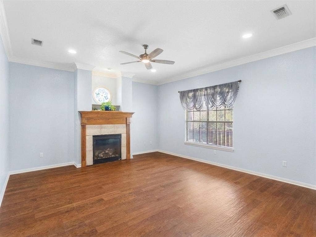 3103 Rim Rock Court, Granbury, TX 76049 Substantial living room features hardwood floors and inviting fireplace