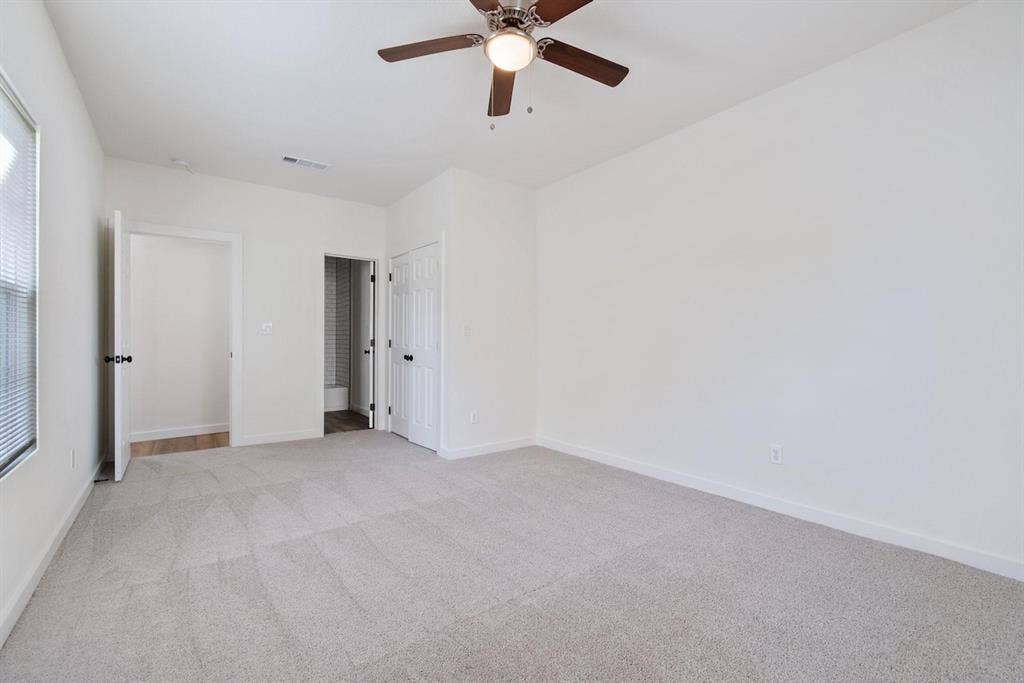 3023 Spurlock Street, Dallas, TX 75223 Neutral-toned wall-to-wall carpeting, ceiling fan with integrated lighting, dual-panel interior doors, and window blinds