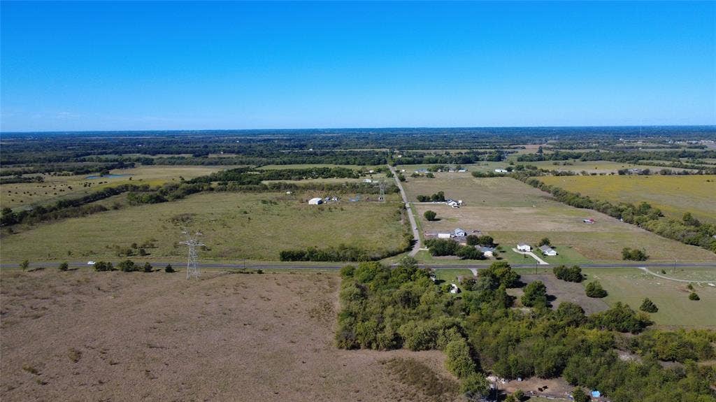 147 Private Road 4330, Greenville, TX 75401 Expansive acreage featuring cleared pasture land, clusters of mature trees, and paved road access