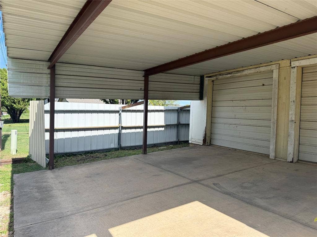 Carport on side corner of property attached to dettached garage with power