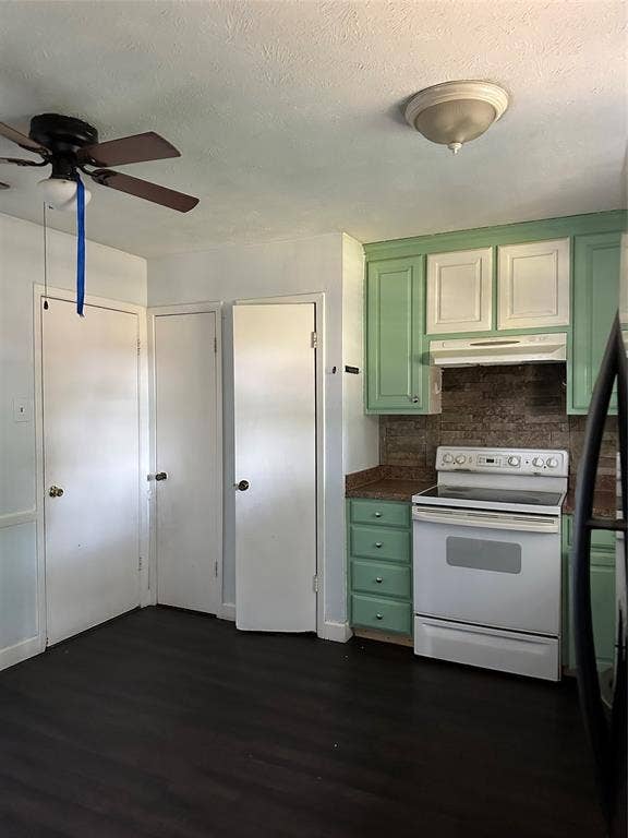 Kitchen featuring wood-finish flooring, two-tone cabinetry, tiled backsplash, and an integrated range hood