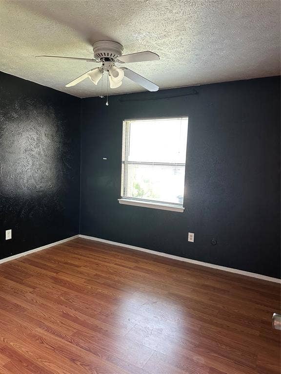 Wood-finish flooring, ceiling fan with integrated lighting, and single-pane window