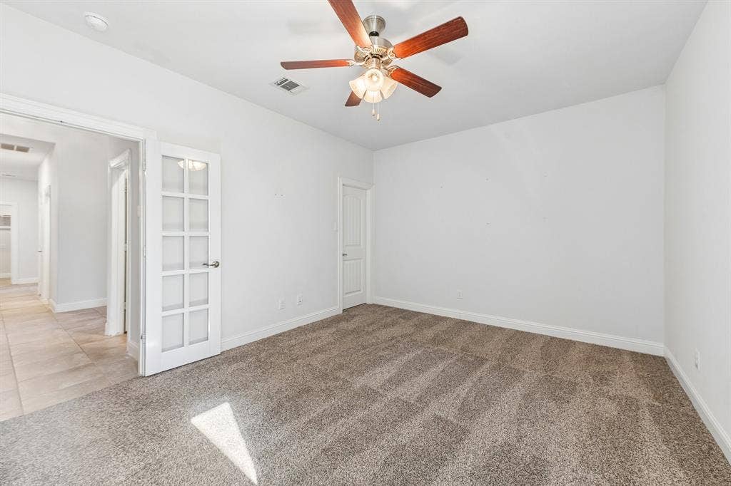 284 Goliad Trail, Forney, TX 75126 Neutral interior featuring wall-to-wall carpeting, a ceiling fan with integrated lighting, and a white French door with glass panels