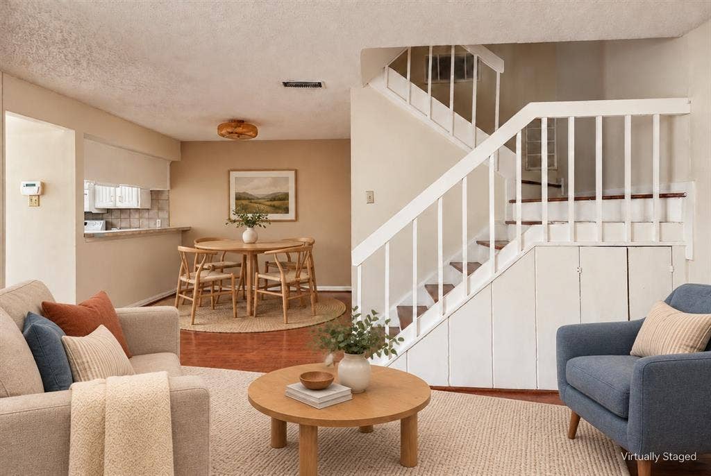 895 Dublin Drive, #4, Richardson, TX 75080 Open interior featuring wood-finish flooring, a staircase with white balusters, and built-in under-stair storage cabinetry