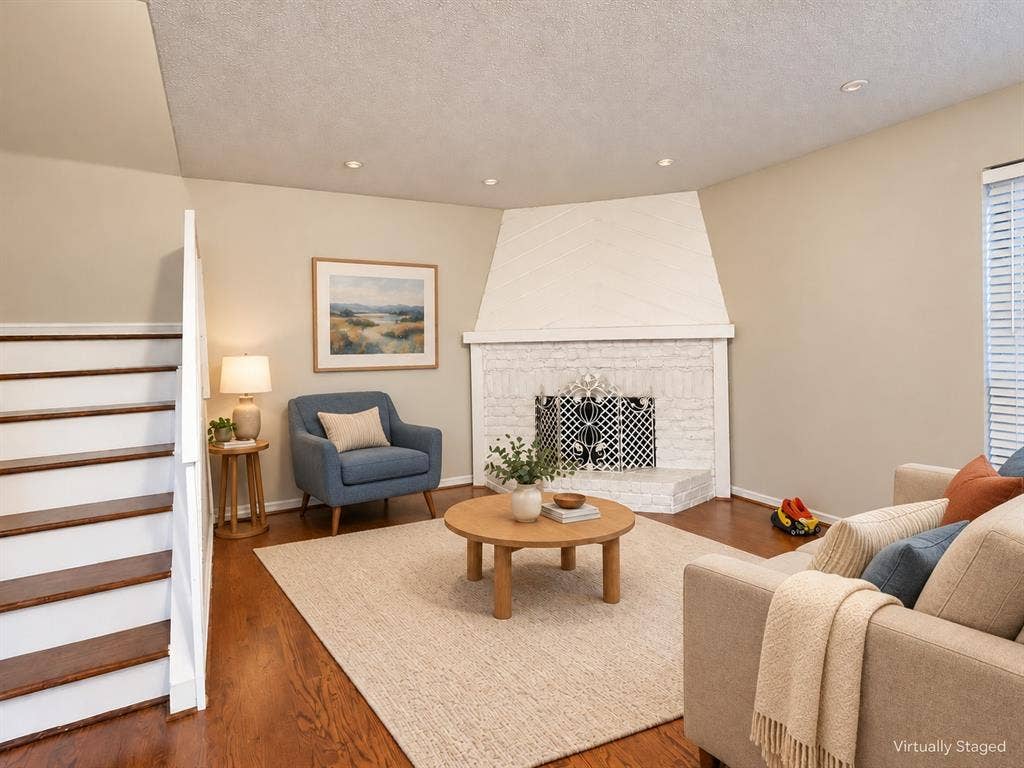 895 Dublin Drive, #4, Richardson, TX 75080 Corner fireplace with a painted brick surround and diagonal wood-paneled accent, wood-finish flooring, and recessed ceiling lighting