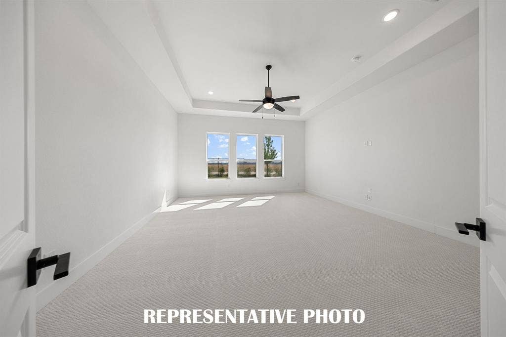Located at the rear of the home and overlooking the peaceful back yard, this owner's suite was designed for rest and relaxation.  REPRESENTATIVE PHOTO