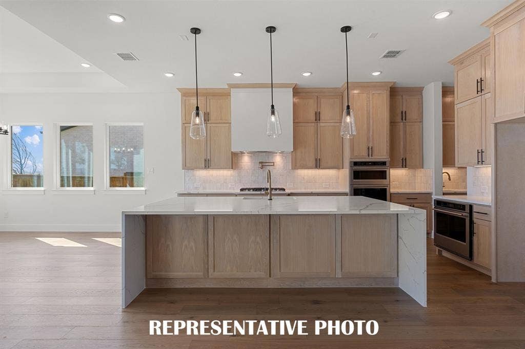 With ample storage and prep space, all the chefs in the family will love creating culinary delights in this dream kitchen!  REPRESENTATIVE PHOTO