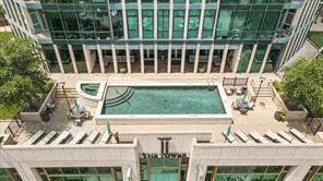 500 Throckmorton Street, #2702, Fort Worth, TX 76102 Elevated outdoor terrace featuring a swimming pool, integrated spa, stone-surfaced deck, and mature landscaping