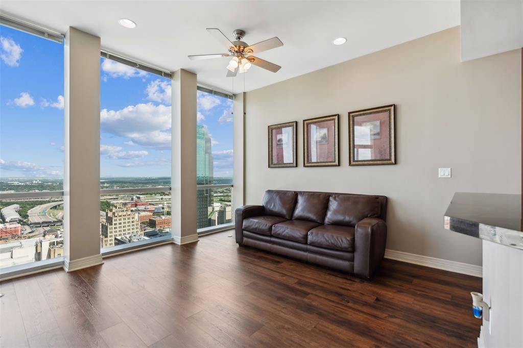 500 Throckmorton Street, #2702, Fort Worth, TX 76102 Floor-to-ceiling windows, wood-finish flooring, recessed lighting, and a multi-blade ceiling fan with integrated lighting