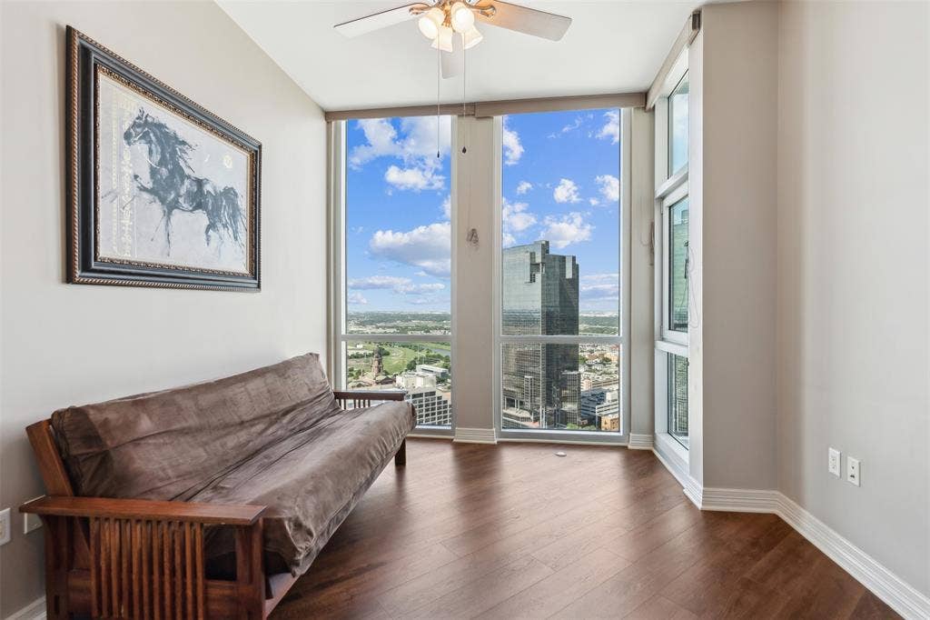 500 Throckmorton Street, #2702, Fort Worth, TX 76102 Floor-to-ceiling windows, wood-finish flooring, and a ceiling-mounted light fixture with fan