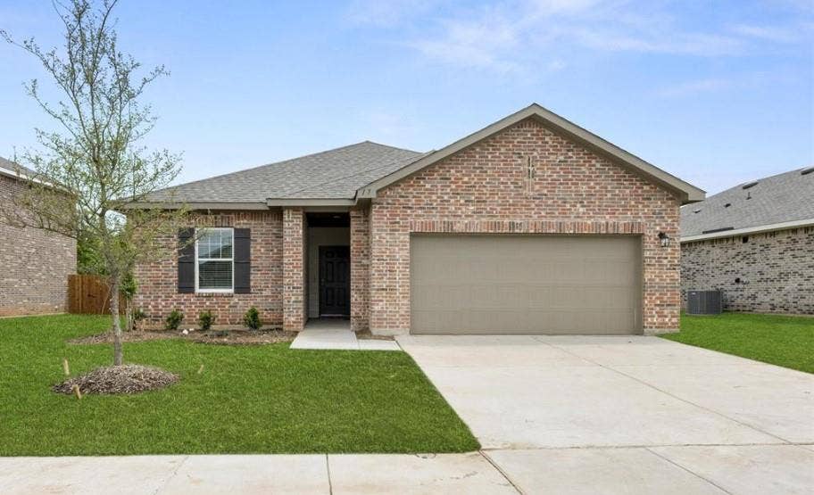 Single-story brick exterior featuring a shingle roof, a two-car garage, and a concrete driveway