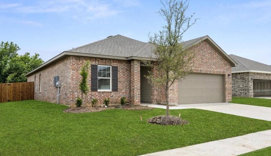 Single-story brick exterior featuring a multi-gable roofline, attached two-car garage, decorative window shutters, and a concrete driveway