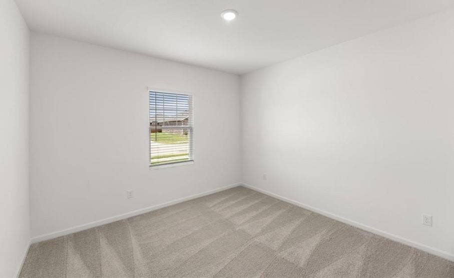 Neutral-toned wall-to-wall carpeting, crisp white walls, recessed ceiling lighting, and a single-pane window with integrated blinds