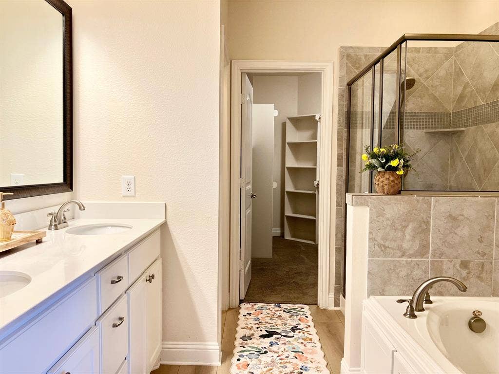 Impeccable! Double sinks, new flooring, tub, shower, toilet room