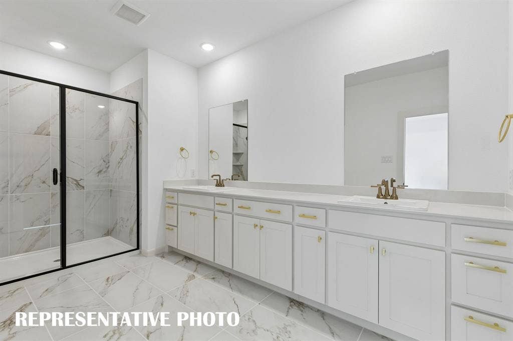 621 Taylor Parkway, Celina, TX 75009 With a spacious walk in shower and plenty of cabinet & counter space, this owner's bath is a dream come true! REPRESENTATIVE PHOTO