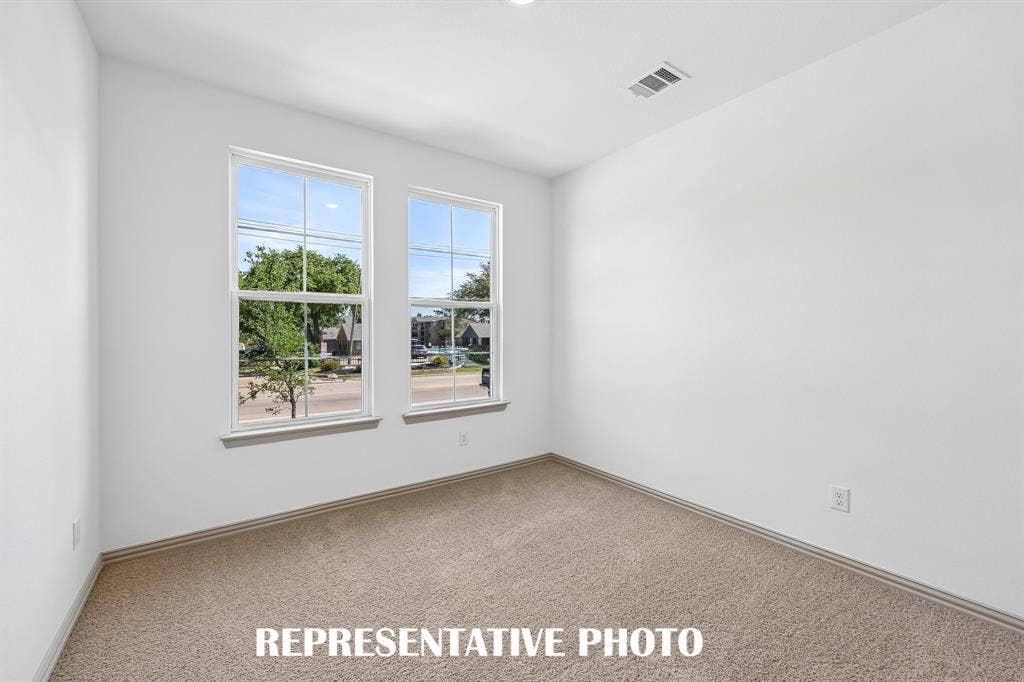 You'll find a nicely sized secondary bedroom on the main floor in our Harper plan.  REPRESENTATIVE PHOTO