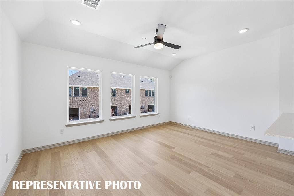 The family room offers a wall of windows that flood the home with natural light.  REPRESENTATIVE PHOTO