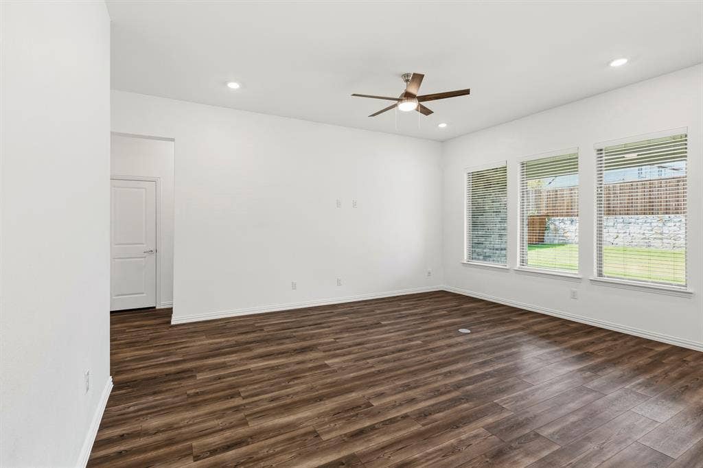 2305 Switchgrass Street, Melissa, TX 75454 Interior space featuring wood-finish flooring, recessed lighting, a ceiling fan with integrated light fixture, and three large windows