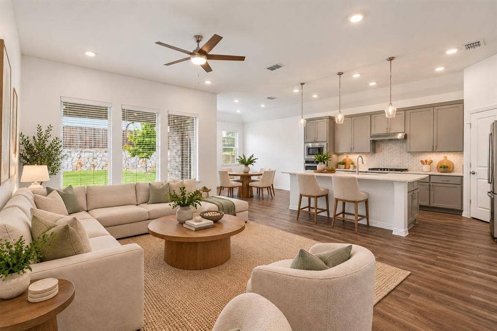 2305 Switchgrass Street, Melissa, TX 75454 Open-concept layout featuring wood-finish flooring, recessed lighting, a center island with quartz countertops, and neutral cabinetry. Virtual photo