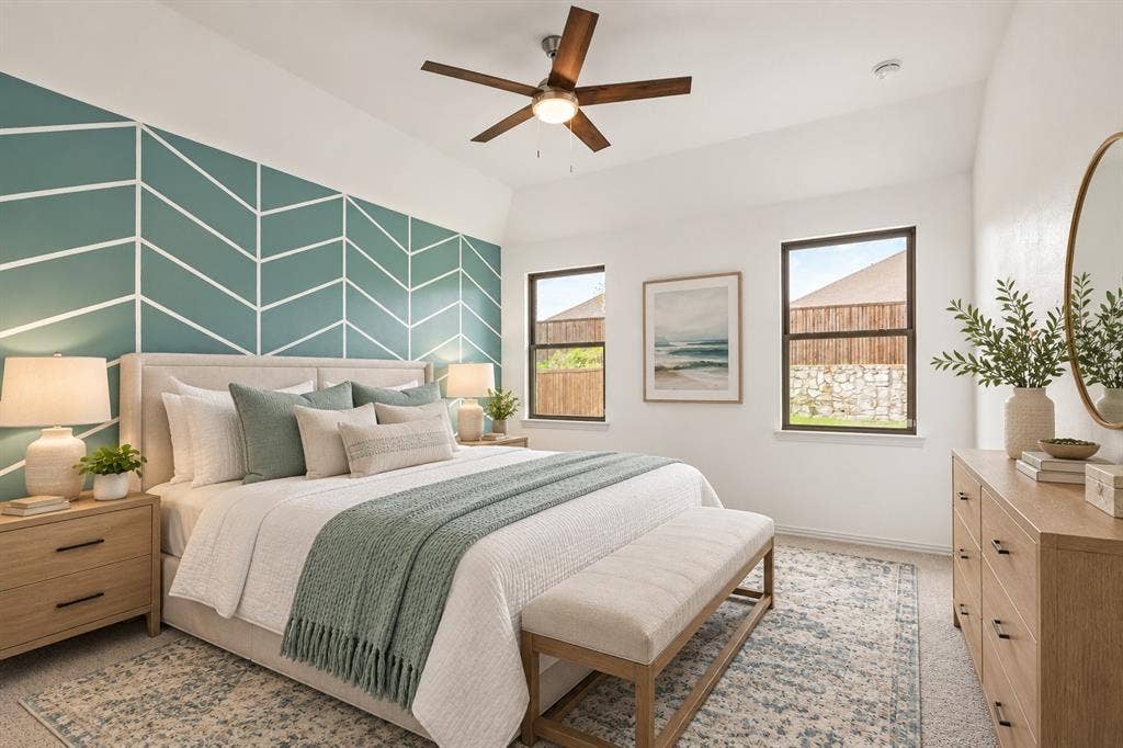 2305 Switchgrass Street, Melissa, TX 75454 Room featuring a tray ceiling, geometric accent wall, and a five-blade ceiling fan with integrated lighting. Virtual photo
