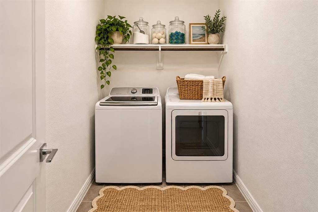 2305 Switchgrass Street, Melissa, TX 75454 Dedicated laundry space featuring neutral ceramic tile flooring and a wall-mounted wooden shelf