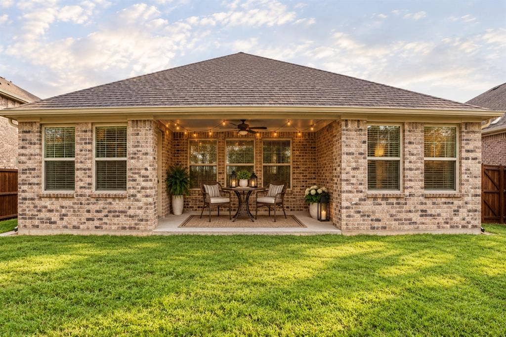 2305 Switchgrass Street, Melissa, TX 75454 Rear exterior featuring a brick facade, covered patio, integrated ceiling fan, recessed lighting, and manicured lawn