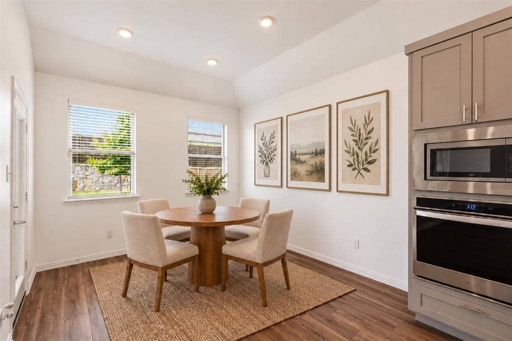 2305 Switchgrass Street, Melissa, TX 75454 Vaulted ceiling, wood-finish flooring, recessed lighting, and built-in stainless steel double wall oven and microwave. Virtual photo